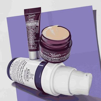 Kiehl's skincare set featuring full-size retinol serum and multi-corrective cream, alongside an eye treatment. Promotional elements indicate price and value.