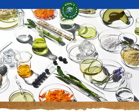 Ingredientes naturales y elementos de laboratorio sobre fondo blanco, con logo 'Kiehl's Mission Renew